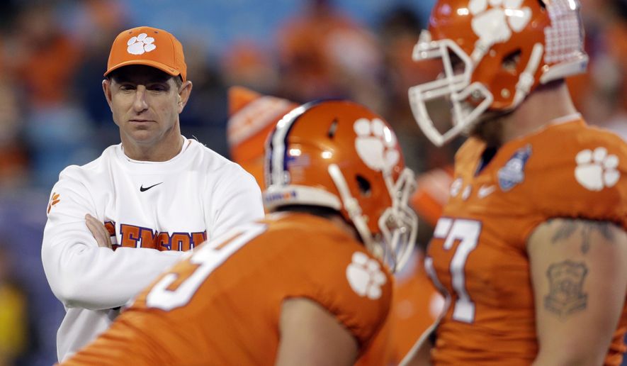 FILE - In this Dec. 5, 2015, file phot, Clemson head coach Dabo Swinney watches prior to the Atlantic Coast Conference championship NCAA college football game against North Carolina in Charlotte, N.C. Three SEC-ACC matchups and Pittsburgh RB James Conner’s emotional return after his fight with cancer headline opening weekend around the Atlantic Coast Conference. North Carolina faces Georgia, Florida State takes on Mississippi and Clemson visits Auburn in three games that could go a long way toward shaping the ACC’s season. (AP Photo/Bob Leverone, File)