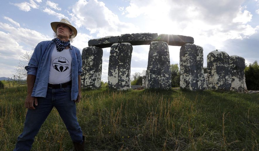 Mark Cline stands before "Foamhendge", his full-sized foam and fiberglass recreation of Stonehendge, located on Rt. 11 near Natural Bridge, Va., Tuesday, April 26, 2016. The Natural Bridge historic area will become part of the state parks system in the near future and Cline has been told to move the sculpture. Foamhenge is getting a new home. The offbeat Rockbridge County attraction has been sold and eventually will be relocated to a family farm near Centreville in Northern Virginia, said Mark Cline, the artist who created and maintained Foamhenge. (Bob Brown/Richmond Times-Dispatch via AP)