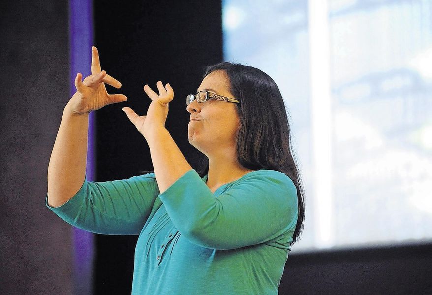 ADVANCE FOR USE SUNDAY, SEPT. 4 - In this Aug. 14, 2016 photo, Melanie Lyons signs while leading the service in song at Paramount Baptist Deaf Church in Amarillo, Texas. (Sean Steffen/The Amarillo Globe News via AP)