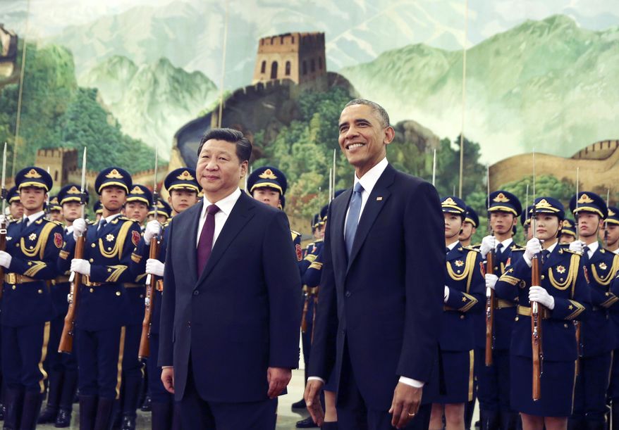 FILE - In this Nov. 12, 2014 file photo, U.S. President Barack Obama, right, smiles after a group of children waved flags and flowers to cheer him during a welcome ceremony with Chinese President Xi Jinping at the Great Hall of the People in Beijing, China. As Barack Obama embarks on what is likely to be his final trip to Asia as president, attention is returning to what is known as the U.S. "pivot" to the continent launched during his first term. The policy adjustment aimed to reinforce alliances and shift military assets to a region that has grown in importance alongside the rise of China as a global economic and political power. (AP Photo/Andy Wong, File)