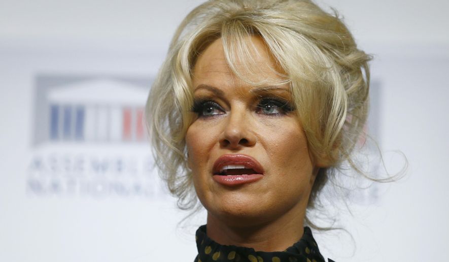 In this Jan. 19, 2016, file photo, Pamela Anderson delivers her speech during a news conference at the French National Assembly to protest the force-feeding of geese used in the production of foie gras, in Paris. (AP Photo/Francois Mori, File)