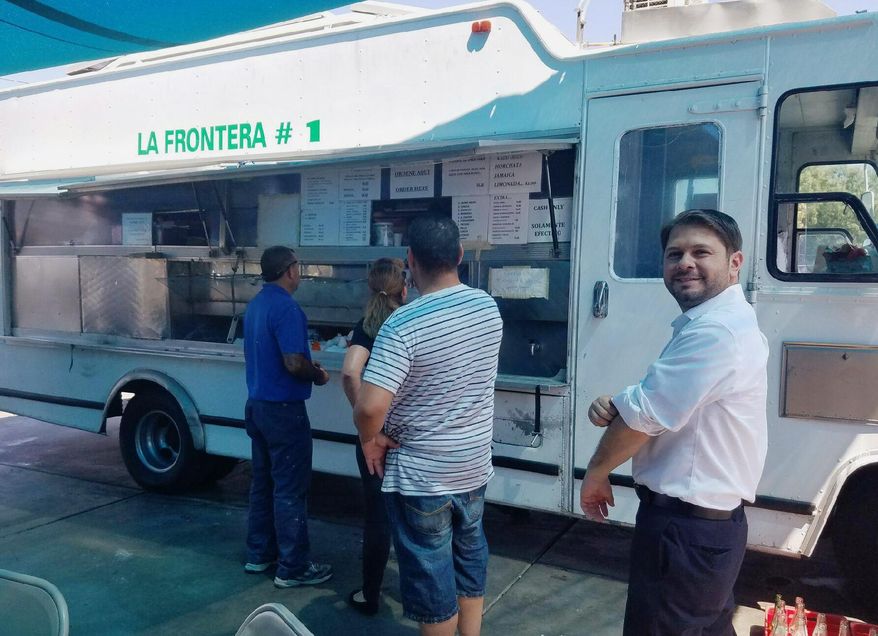 In this photo provided by Monica Sandschafer, Congressman Ruben Gallego is seen standing in line at a taco truck in Phoenix on Friday, Sept. 2, 2016. A Hispanic Donald Trump supporter's assertion that without Trump there could one day be “taco trucks on every corner” in the U.S. stirred ridicule, not to mention hunger, across the internet Friday. (Monica Sandschafer via AP)