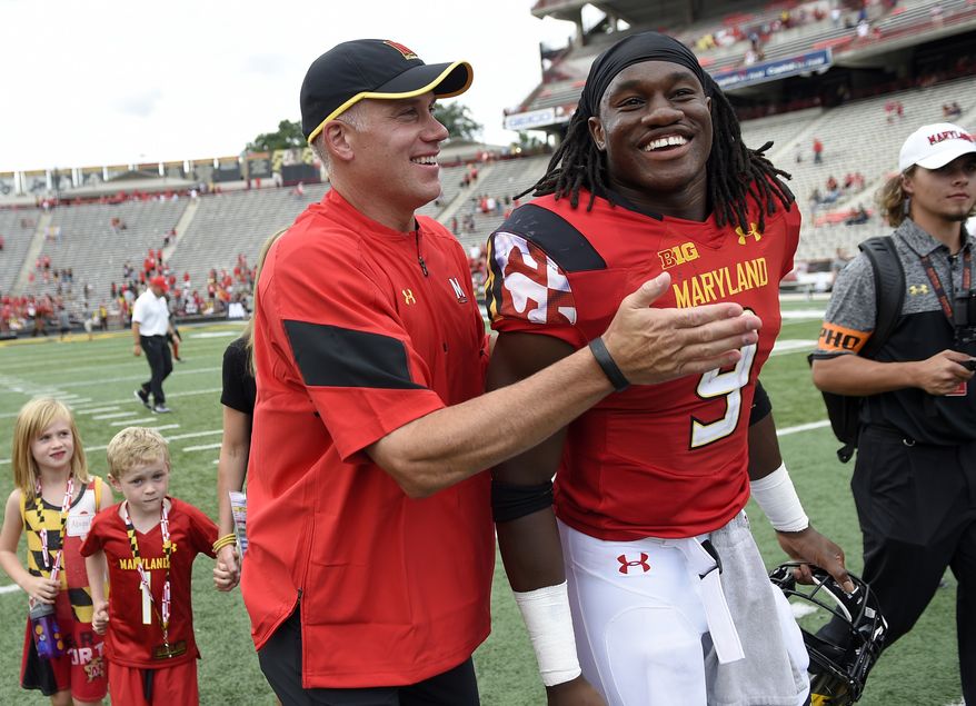 Maryland head coach DJ Durkin, left, reacts with running back Trey Edmunds (9) as the walk off after an NCAA football game against Howard, Saturday, Sept. 3, 2016, in College Park, Md. Maryland won 52-13. (AP Photo/Nick Wass)