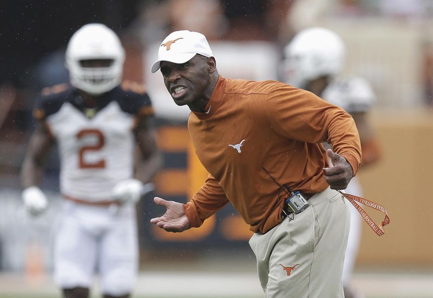 FILE - In this April 16, 2016, file photo, Texas head coach Charlie Strong talks to his players during a spring NCAA college football game in Austin, Texas. Strong enters his third season at the helm with Texas hosting No. 10 Notre Dame on Sunday night, Sept. 4. (AP Photo/Eric Gay, File)