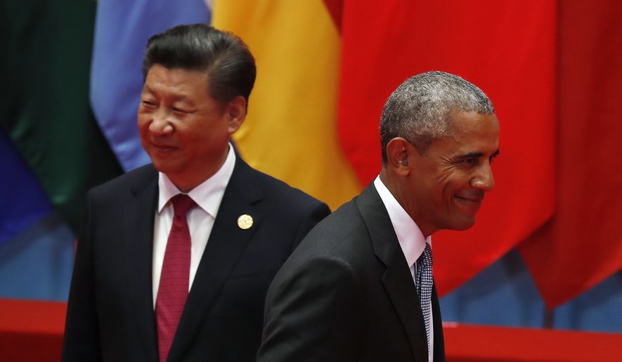 President Obama walks past Chinese President Xi Jinping as he arrives for a group photo session for the G-20 Summit in Hangzhou, China, on Sunday. (Associated Press)