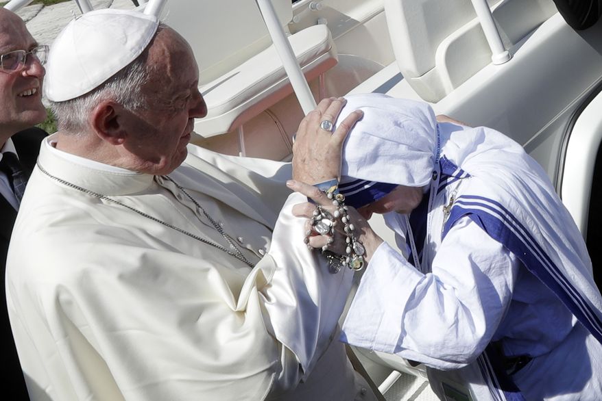 Pope Francis blesses a nun of the Sisters of the Missionaries of Charity as he leaves at the end of the Canonization Mass of Mother Teresa in St. Peter's Square, at the Vatican on Sunday. (Associated Press)