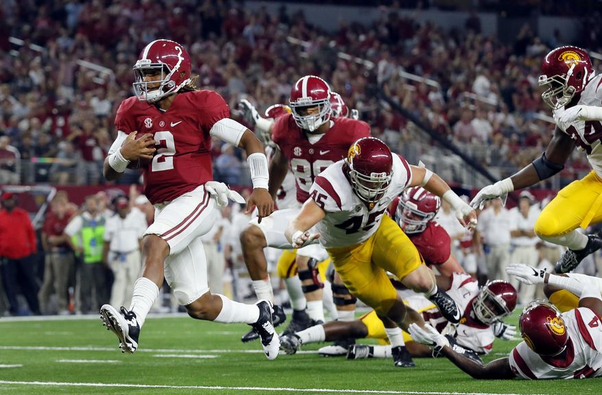 Alabama quarterback Jalen Hurts slips into the end zone on a 7-yard touchdown run during the second half of an NCAA college football game against Southern California on Saturday, Sept. 3, 2016, in Arlington, Texas. (AP Photo/Tony Gutierrez)