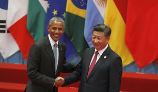 U.S. President Barack Obama, left, shakes hands with China&#39;s President Xi Jinping before a group photo session for the G20 Summit in Hangzhou in eastern China&#39;s Zhejiang province, Sunday, Sept. 4, 2016. (AP Photo/Ng Han Guan)