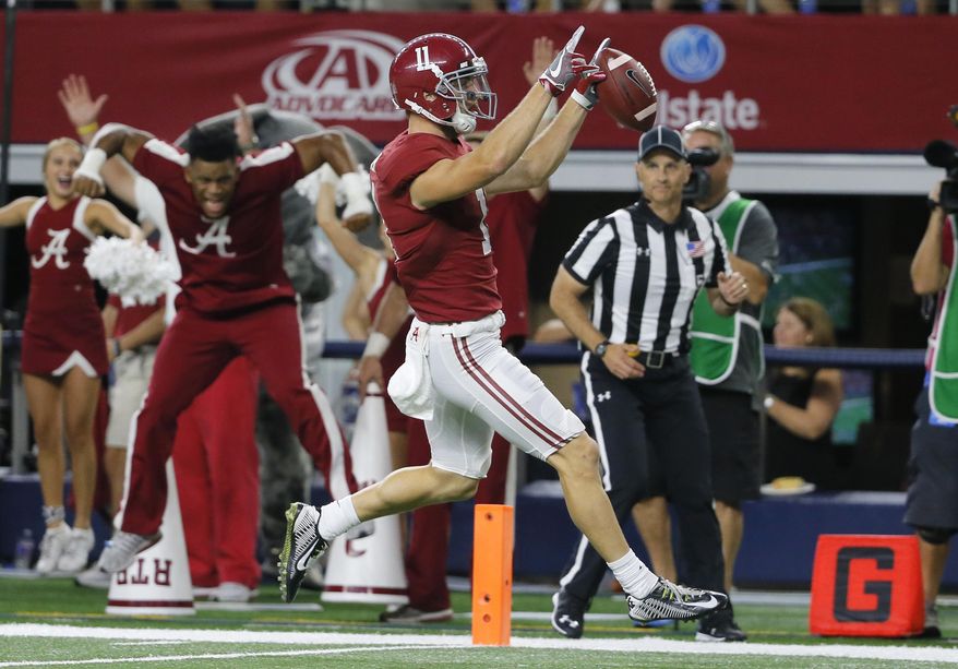 Alabama wide receiver Gehrig Dieter celebrates as he crosses into the end zone after catching a pass during the second half of an NCAA college football game against Southern California on Saturday, Sept. 3, 2016, in Arlington, Texas. (AP Photo/Tony Gutierrez)