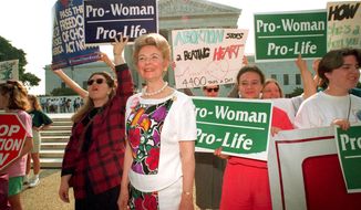 Anti-abortion demonstrators, including Phyllis Schlafly, foreground, rally at the U.S. Supreme Court in Washington, D.C., on June 29, 1992.  The high court upheld most provisions of a restrictive Pennsylvania abortion law.  (AP Photo/Marcy Nighswander)