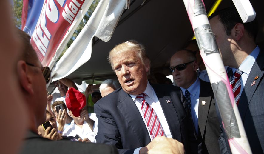Then-Republican presidential candidate Donald Trump shakes hands during a visit to the Canfield Fair, Monday, Sept. 5, 2016, in Canfield, Ohio. (AP Photo/Evan Vucci) ** FILE **