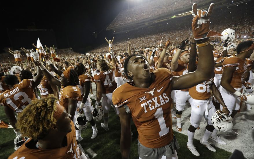 Texas wide receiver John Burt (1) celebrates with teammates after they defeated Notre Dame in double overtime in a NCAA college football game, Sunday, Sept. 4, 2016, in Austin, Texas. Texas won 50-47. (AP Photo/Eric Gay)