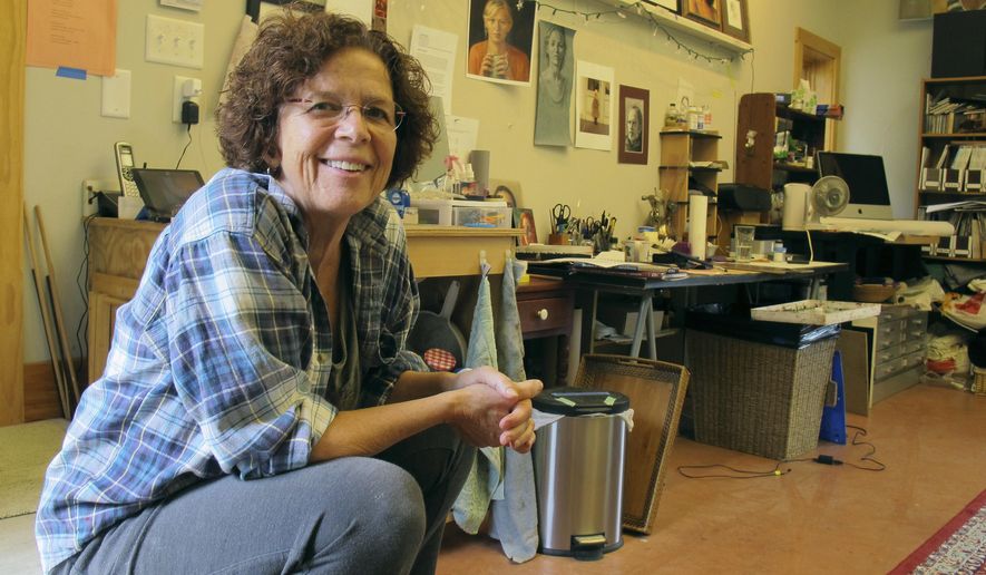 In this Aug. 31, 2016 photo, portrait artist August Burns sits in her studio in Middlesex, Vt. Burns was chosen to paint the official portrait of Gov. Peter Shumlin, who leaves office in January. Burns said she hopes to create not just a portrait, but a work of art. (AP Photo/Wilson Ring)