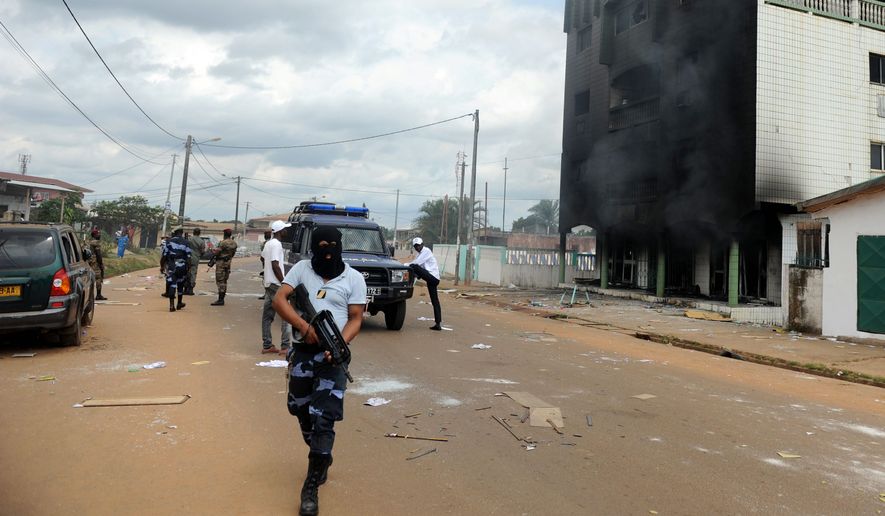 Police stand guard following an election protest in Libreville, Gabon. Post-election violence in Gabon has killed between 50 and 100 people, the opposition presidential candidate said Tuesday, a toll much higher than the government&#39;s count. (Associated Press)