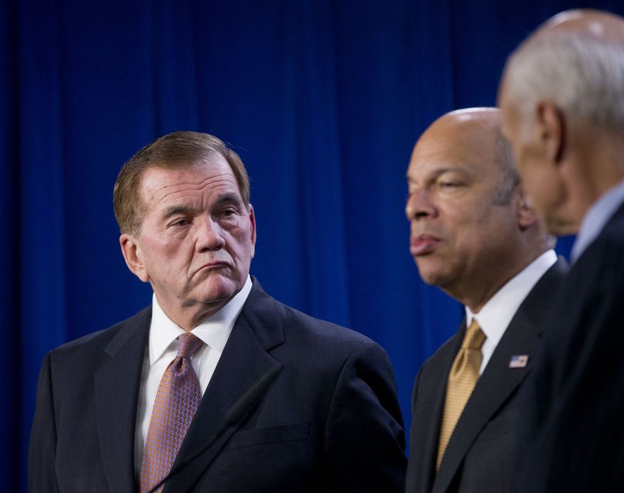 Former Homeland Security Secretary Tom Ridge (left) listens as current Homeland Security Secretary Jeh Johnson speaks during a news conference in Washington on Feb. 25, 2015. At right is former Homeland Security Secretary Michael Chertoff. (Associated Press) **FILE**