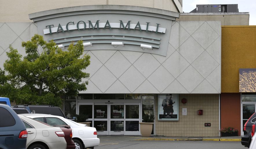 Cars are parked near an entrance to the Tacoma Mall, Wednesday, Sept. 7, 2016, in Tacoma, Wash. A Washington state teenager who was riding her bicycle through the mall parking lot when an off-duty officer working as a security guard threw her to the ground and shocked her with a stun gun is suing the Tacoma Police Department. (AP Photo/Ted S. Warren)