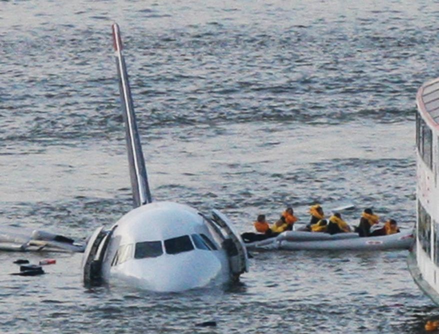FILE - In this Jan. 15, 2009 file photo, passengers in an inflatable raft move away from an Airbus 320 US Airways aircraft that has gone down in the Hudson River in New York. Accident investigators say they object to their portrayal in a new movie based on the “Miracle on the Hudson” river ditching of airliner seven years ago after striking geese. (AP Photo/Bebeto Matthews, File)