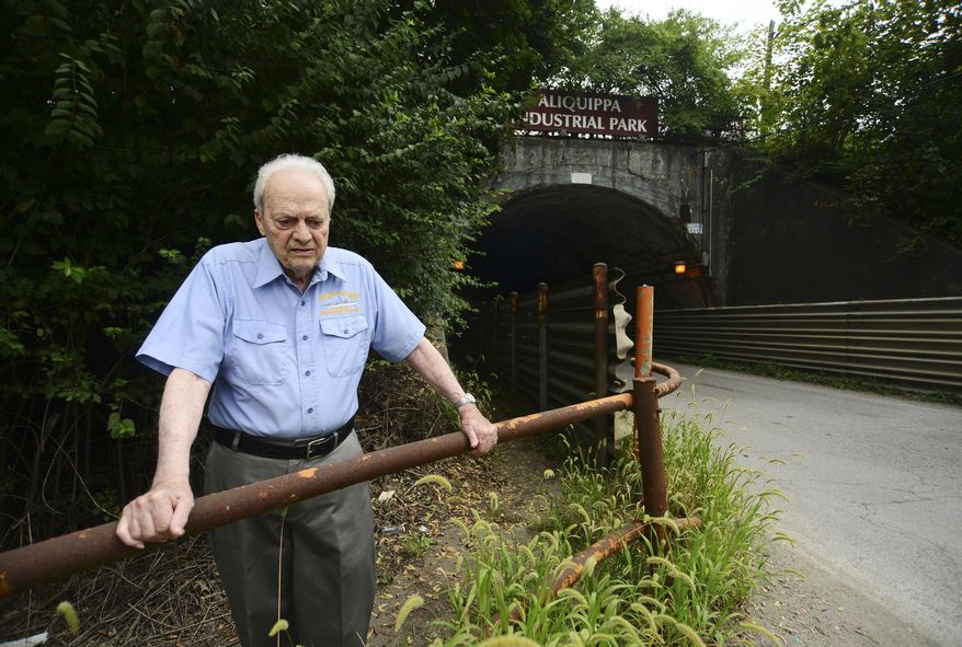 ADVANCE FOR RELEASE SATURDAY, SEPTEMBER 10, 2016, AT 3:01 A.M. EDT. AND THEREAFTER - In this Aug. 31, 2016, photo, Gino Piroli stands in front of the tunnel which leads to the Aliquippa Industrial Park, which used to be the entrance to the former J & L property in Aliquippa, Pa. Workers' rights might not even exist today if it weren't for a U.S. Supreme Court case that unfolded in Aliquippa in 1937. To Piroli, the 1937 Supreme Court decision was more than just a blurb in history books. (Lucy Schaly/Beaver County Times via AP)