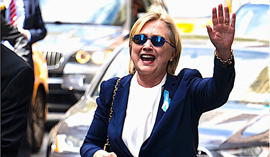Hillary Clinton waves to confirm she was feeling better on Sunday after leaving the 9/11 anniversary ceremony in New York early due to feeling &quot;overheated.&quot; (Associated Press)
