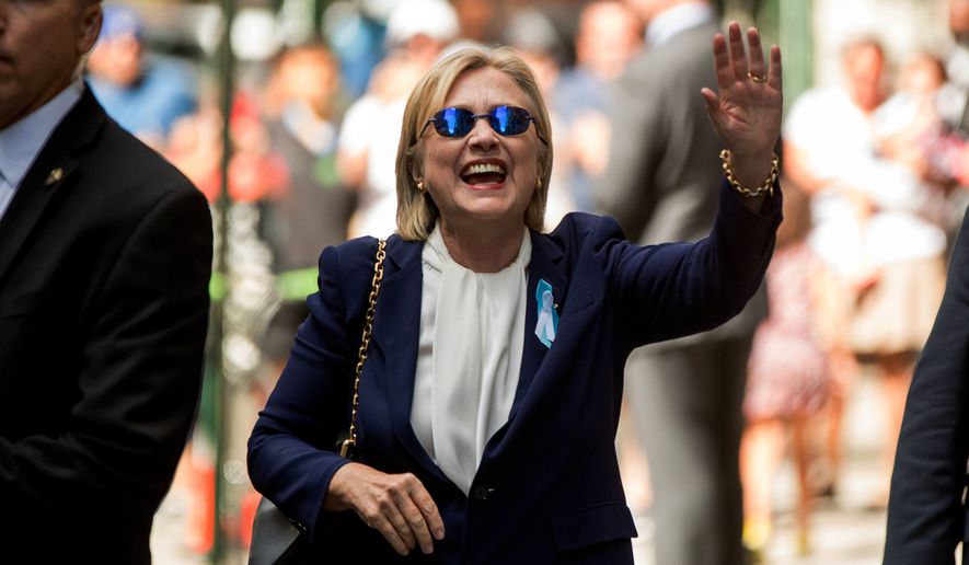 Democratic presidential candidate Hillary Clinton waves after leaving an apartment building Sunday, Sept. 11, 2016, in New York. Clinton&#x27;s campaign said the Democratic presidential nominee left the 9/11 anniversary ceremony in New York early after feeling &quot;overheated.&quot; (AP Photo/Andrew Harnik)