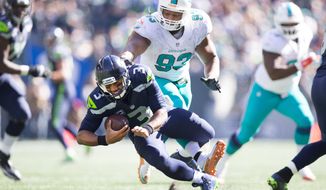 Miami Dolphins defensive tackle Ndamukong Suh (93) steps on Seattle Seahawks quarterback Russell Wilson&#39;s foot in the third quarter of an NFL football game in Seattle, Sunday, Sept. 11, 2016. (Dean Rutz/The Seattle Times via AP)