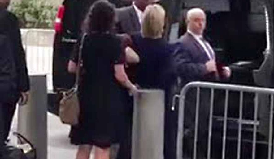 Hillary Clinton (center) leaving the 9/11 commemoration Sunday