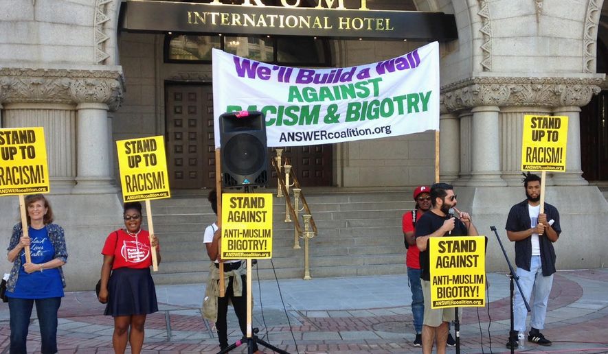 A small group of protesters demonstrate against Republican presidential nominee Donald Trump outside the newly opened Trump International Hotel in downtown Washington, D.C. Monday, The luxury hotel occupies the site of the Old Post Office building. (Ryan M. McDermott/THE WASHINGTON TIMES)
