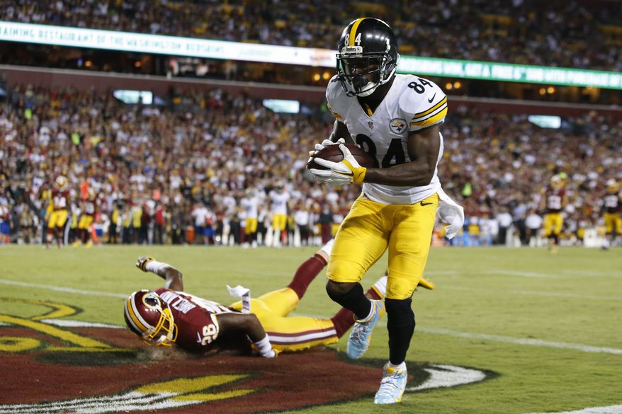 Washington Redskins cornerback Bashaud Breeland (26) lands on the turf as Pittsburgh Steelers wide receiver Antonio Brown (84) scores a touchdown during the second half of an NFL football game in Landover, Md., Monday, Sept. 12, 2016. (AP Photo/Alex Brandon)