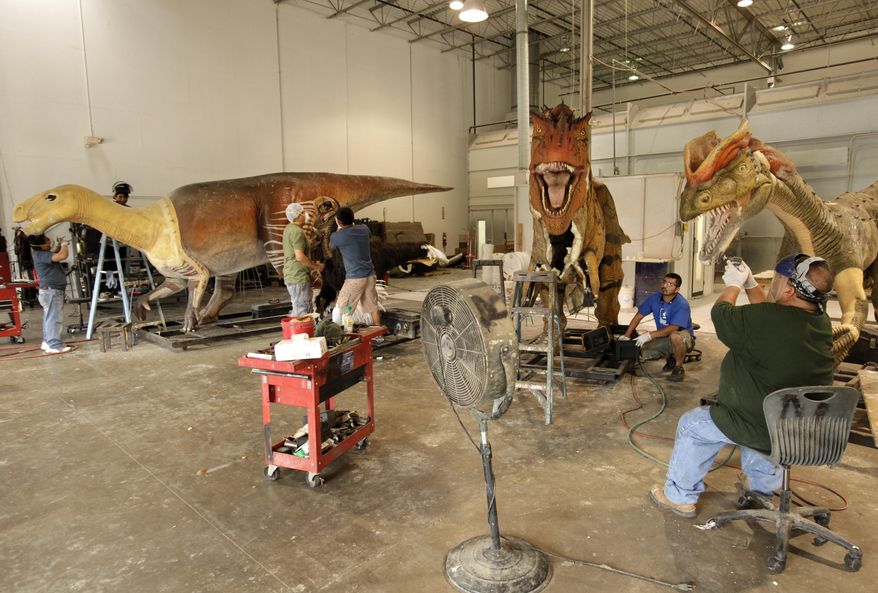 Employees build animatronic dinosaurs at Billings Productions in Allen, Texas, on Aug. 29, 2016. (Jason Janik/The Dallas Morning News via AP)