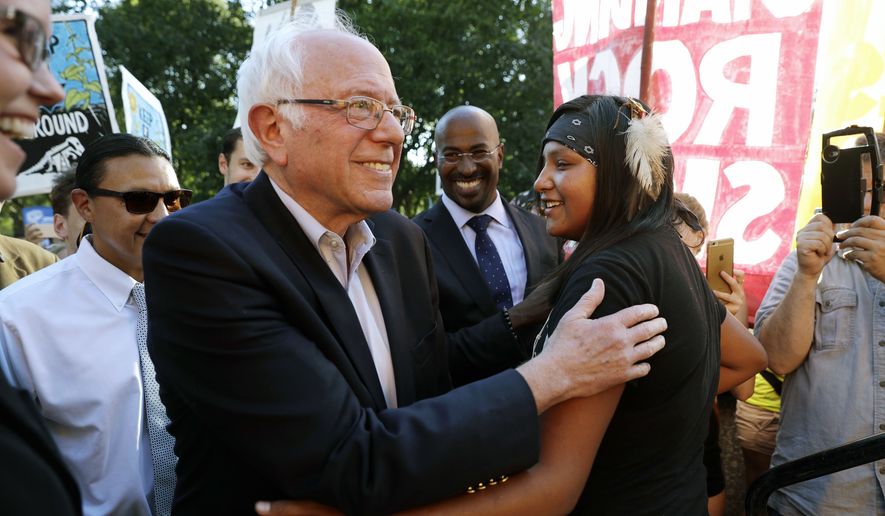 Sen. Bernie Sanders, I-Vt., left, greets Jasilyn Charger, a member of the Cheyenne River Sioux Tribal Youth Council, after Charger spoke to a group of supporters of the Standing Rock Sioux Tribe who were rallying in opposition of the Dakota Access oil pipeline, during a rally by the White House, Tuesday, Sept. 13, 2016, in Washington. Sanders also spoke at the rally. (AP Photo/Jacquelyn Martin) ** FILE **