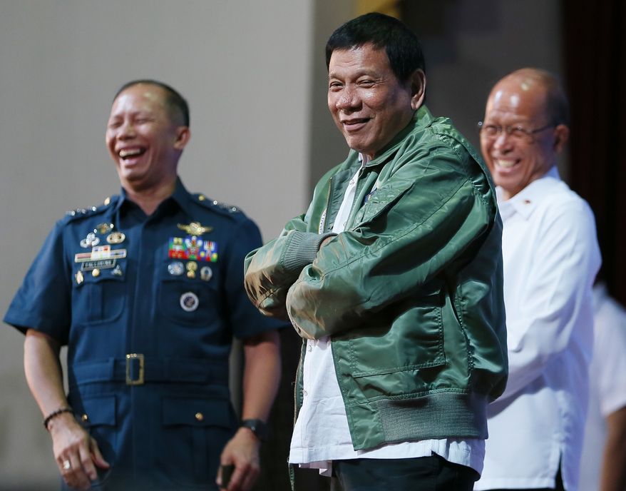Philippine President Rodrigo Duterte wears a pilot's jacket which was presented to him during his "Talk with the Airmen" on the anniversary of the 250th Presidential Airlift Wing Tuesday, Sept. 13, 2016 at the Philippine Air Force headquarters in suburban Pasay city, southeast of Manila, Philippines. On Monday, President Duterte, in his first public statement opposing the presence of American troops, said he wants U.S. forces out of his country's south and blamed America for inflaming Muslim insurgencies in the region.(AP Photo/Bullit Marquez)