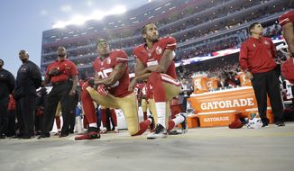 San Francisco 49ers safety Eric Reid (35) and quarterback Colin Kaepernick (7) kneel during the national anthem before an NFL football game against the Los Angeles Rams in Santa Clara, Calif., Monday, Sept. 12, 2016. (AP Photo/Marcio Jose Sanchez)