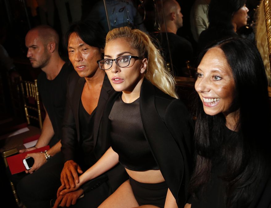 Lady Gaga, second from right, poses for pictures before the Brandon Maxwell Spring 2017 collection is modeled during Fashion Week at the Russian Tea Room in New York, Tuesday, Sept. 13, 2016. (AP Photo/Seth Wenig)