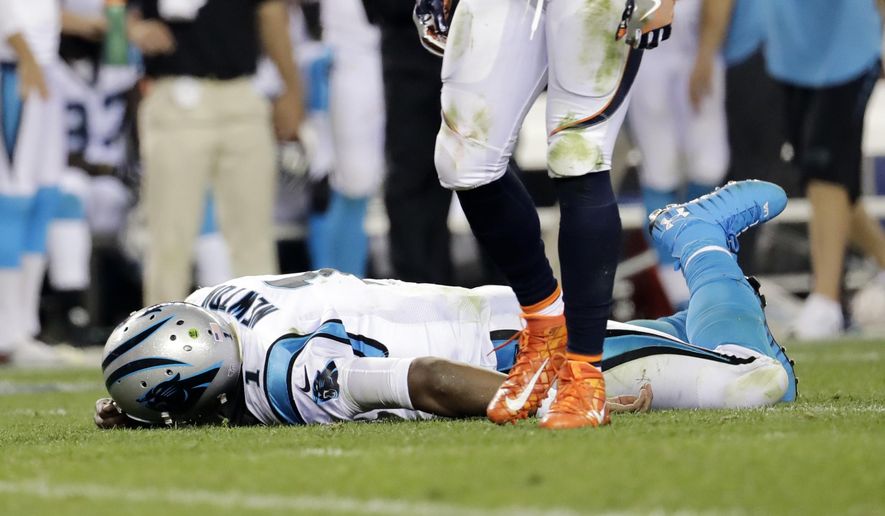 FILE - In this Sept. 8, 2016, file photo, Carolina Panthers quarterback Cam Newton (1) lies on the turf after a roughing the passer penalty was called on Denver Broncos free safety Darian Stewart (26) during the second half of an NFL football game in Denver. s some Broncos players prepare to face the financial consequences of their helmet-to-helmet hits on Cam Newton, they insist they're not a dirty defense, although they don't really mind if that's their reputation. (AP Photo/Joe Mahoney, File) **FILE**
