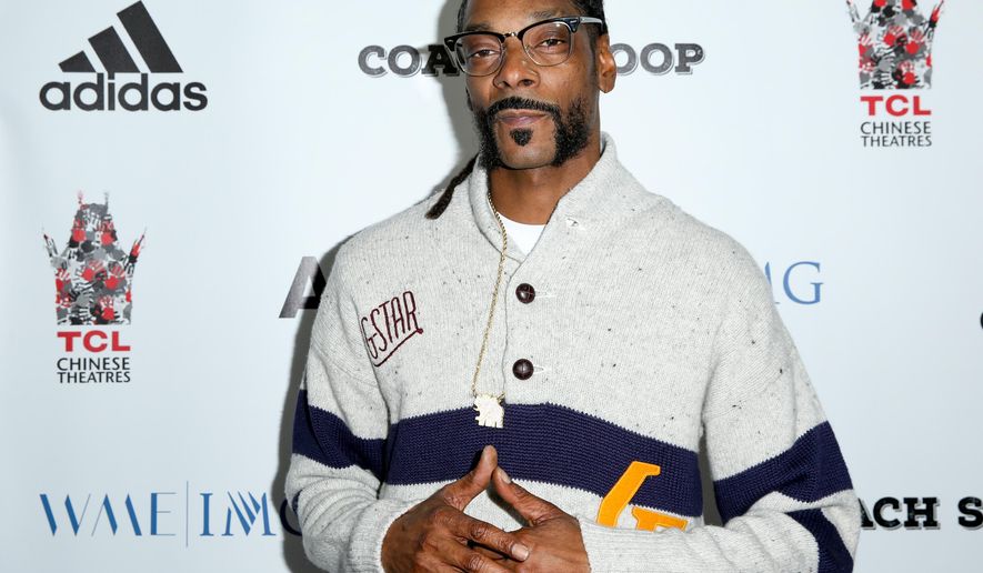 FILE- In this May 16, 2016, file photo, Snoop Dogg arrives at the LA Premiere of "Coach Snoop" at the TCL Chinese 6 Theatres in Los Angeles. Snoop Dogg, known for his ultra-smooth West Coast swagger and rap style, will be honored with the “I Am Hip Hop” award at the 11th annual BET Hip-Hop Awards. BET said Tuesday, Sept. 13, that Snoop Dogg will receive the award on Saturday during the taped event at the Cobb Energy Performing Centre in Atlanta. The show will on BET on Oct. 4. (Photo by Rich Fury/Invision/AP, File)