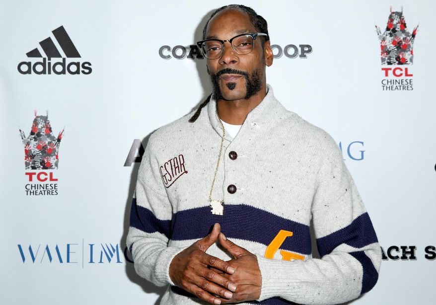 FILE- In this May 16, 2016, file photo, Snoop Dogg arrives at the LA Premiere of "Coach Snoop" at the TCL Chinese 6 Theatres in Los Angeles. Snoop Dogg, known for his ultra-smooth West Coast swagger and rap style, will be honored with the “I Am Hip Hop” award at the 11th annual BET Hip-Hop Awards. BET said Tuesday, Sept. 13, that Snoop Dogg will receive the award on Saturday during the taped event at the Cobb Energy Performing Centre in Atlanta. The show will on BET on Oct. 4. (Photo by Rich Fury/Invision/AP, File)