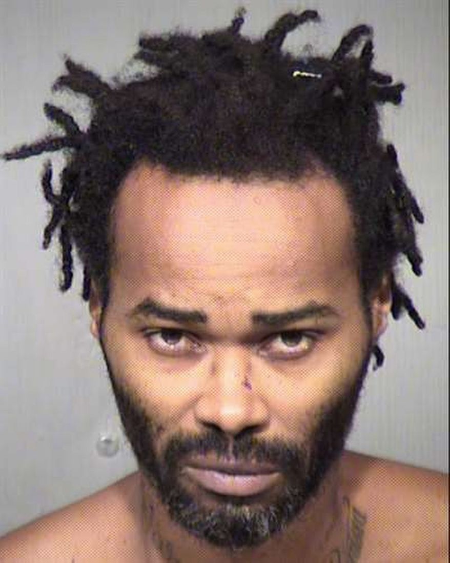 Marc LaQuon Payne was jailed without bond after authorities said he drove a car into two police officers outside a Phoenix gas station on Tuesday. He then scuffled with a third officer who got away. (Maricopa County Sheriff via Associated Press)