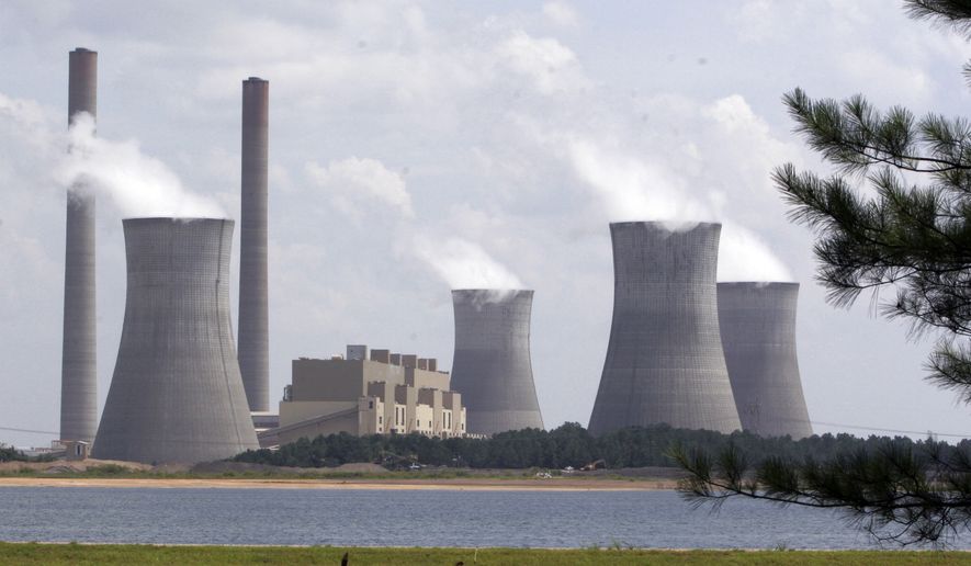 In this July 10, 2007, file photo, the coal-fired Plant Scherer is in operation at Juliette, Ga. Most Americans are willing to pay a little more each month to fight global warming, but only a tiny bit, according to a new poll. (AP Photo/Gene Blythe, File)