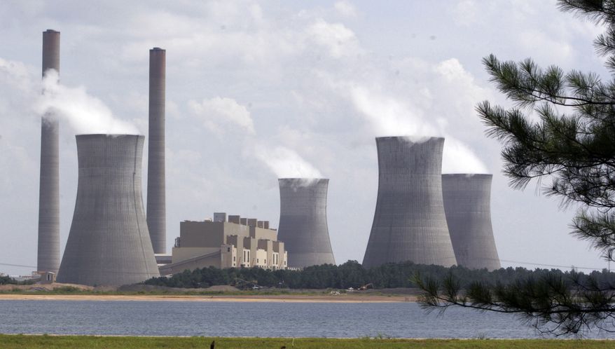 In this July 10, 2007, file photo, the coal-fired Plant Scherer is in operation at Juliette, Ga. Most Americans are willing to pay a little more each month to fight global warming, but only a tiny bit, according to a new poll. (AP Photo/Gene Blythe, File)