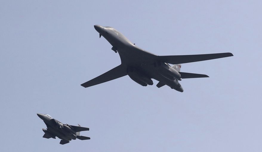 CORRECTS THE SECOND SENTENCE TO REMOVE REFERENCE TO "NUCLEAR-CAPABLE" - A U.S. B-1B bomber, right, flies over Osan Air Base with a U.S. jet in Pyeongtaek, South Korea, Tuesday, Sept. 13, 2016. The United States on Tuesday sent two supersonic bombers streaking over ally South Korea in a show of force meant to cow North Korea after its recent nuclear test, and also to settle rattled nerves in the South. (AP Photo/Lee Jin-man)