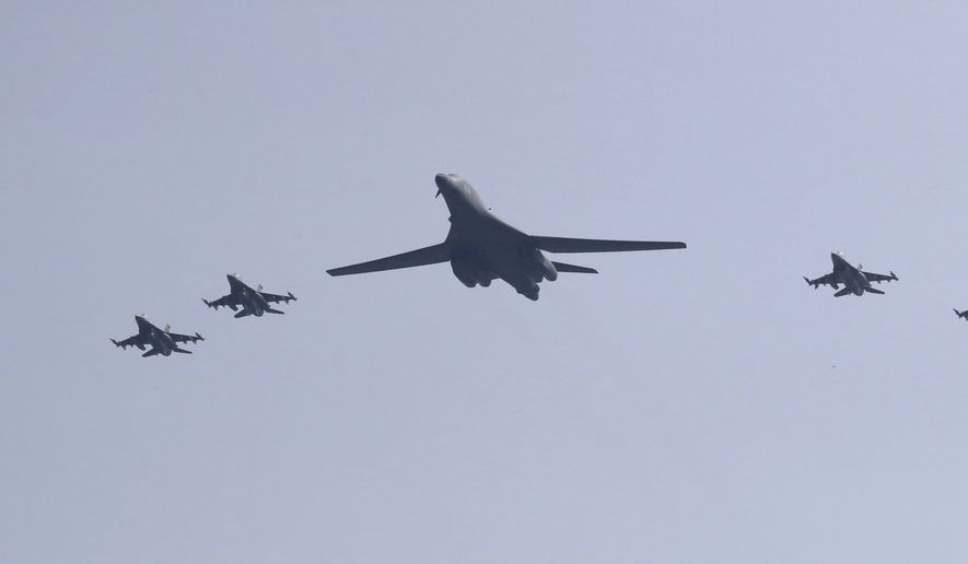 CORRECTS THE SECOND SENTENCE TO REMOVE REFERENCE TO "NUCLEAR-CAPABLE" - A U.S. B-1B bomber, center, flies over Osan Air Base with U.S. jets in Pyeongtaek, South Korea, Tuesday, Sept. 13, 2016. The United States on Tuesday sent two supersonic bombers streaking over ally South Korea in a show of force meant to cow North Korea after its recent nuclear test, and also to settle rattled nerves in the South. (AP Photo/Lee Jin-man)