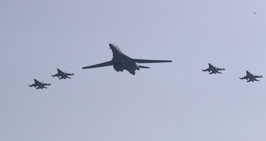 CORRECTS THE SECOND SENTENCE TO REMOVE REFERENCE TO "NUCLEAR-CAPABLE" - A U.S. B-1B bomber, center, flies over Osan Air Base with U.S. jets in Pyeongtaek, South Korea, Tuesday, Sept. 13, 2016. The United States on Tuesday sent two supersonic bombers streaking over ally South Korea in a show of force meant to cow North Korea after its recent nuclear test, and also to settle rattled nerves in the South. (AP Photo/Lee Jin-man)