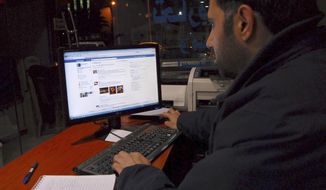A man uses the internet at a cafe in Damascus, Syria. (Associated Press)