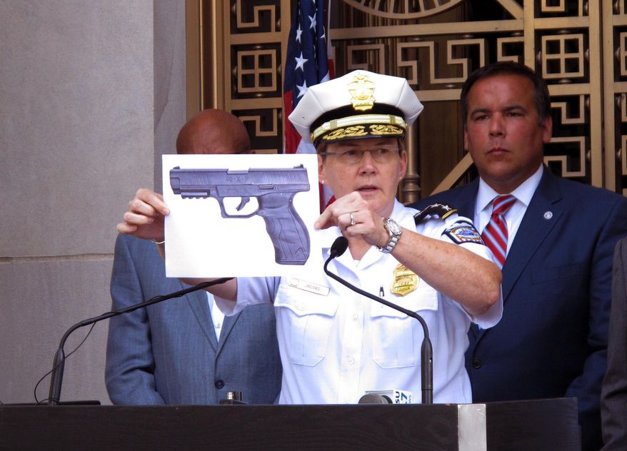 CORRECTS NAME FROM TYREE KING TO TYRE KING -Columbus Police Chief Kim Jacobs holds up a photo showing the type of BB gun that police say a 13-year-old boy pulled from his waistband just before he was shot and killed by police investigating an armed robbery report, on Thursday, Sept. 15, 2016 in Columbus, Ohio. Police say the boy, Tyre King, died at a hospital after the Wednesday evening shooting. (AP Photo/Andrew Welsh-Huggins)