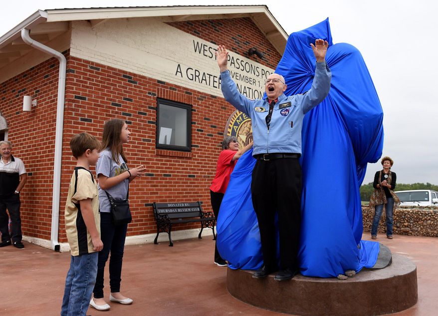 NASA Astronaut and home town hero Capt. Alan Bean starts a count down before a statue unveiling at the Wheeler Historical Museum in Amarillo, Texas, Wednesday, Sept. 14, 2016. Bean returned to his birthplace for the unveiling of the 8½-foot, 1,300-pound statue titled "Tiptoeing on the Oceans of Storms", that was sculpted by Amarillo's Mickey Wells. (Michael Schumacher/Amarillo Globe-News via AP)