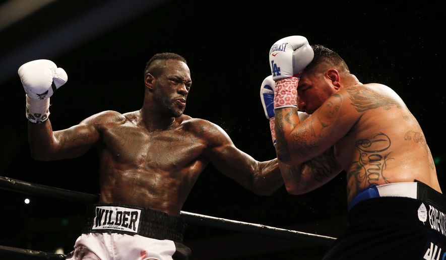 Deontay Wilder punches Chris Arreola during the WBC heavyweight boxing match, Saturday, July 16, 2016, in Birmingham, Ala. (AP Photo/Brynn Anderson)