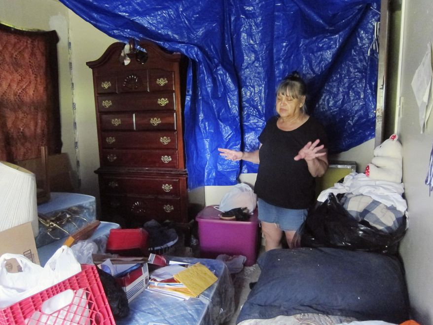Margaret Gaines, of Houston, stands in her bedroom Friday, Sept. 16, 2016, as she talks about how part of the roof of her home collapsed onto her bed in August. The Gaines said the roof had previously been fixed after it was damaged by Hurricane Ike in 2008, but she blamed shoddy repair work for the new collapse. Gaines has applied for help in fixing her roof through the city of Houston's new "Blue Tarp Program," which is working to help repair roofs damaged during Ike or other storms. (AP Photo/Juan A. Lozano)