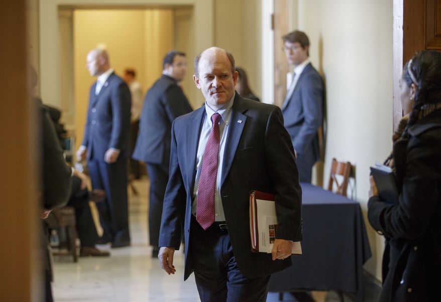 FILE - In this Nov. 18, 2014 file photo, Sen. Chris Coons, D-Del. walks on Capitol Hill in Washington. The Senate has approved a bill to boost efforts to combat illegal wildlife poaching and trafficking, a growing worldwide problem with an estimated cost of up to $10 billion a year. The measure, sponsored by Coons and Sen. Jeff Flake, R-Ariz., was approved unanimously late Thursday, Sept. 15, 2016. The senators have traveled together to a host of African countries and have pushed for the bill since last year. (AP Photo/J. Scott Applewhite, File)