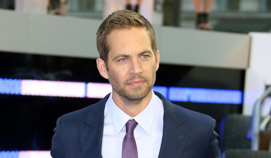 In this May 7, 2013, file photo, actor Paul Walker arrives for the World Premiere of "Fast & Furious 6," in central London. Walker's brother, Caleb, told "Entertainment Tonight" in a story published online on Sept. 15, 2016, that he has had a discussion with franchise co-star Vin Diesel about and when they may be able to bring Paul Walker’s character, Brian O’Conner, back for a cameo. Paul Walker died in a November 2013 car accident. (Photo by Joel Ryan/Invision/AP, File)