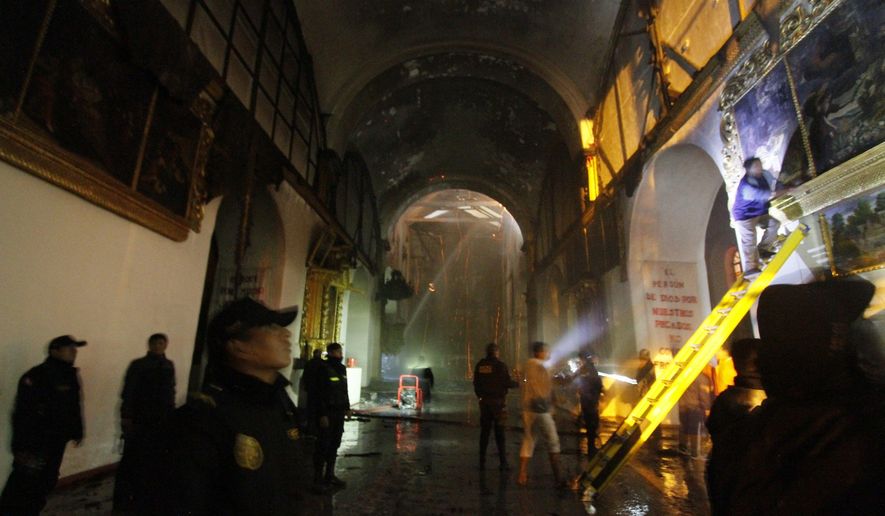 Firefighters and police inspect the famed 16th century San Sebastian church after it was partially destroyed by fire in Cuzco, Peru, Friday, Sept. 16, 2016. The blaze that burned into Friday morning destroyed the ornate, gilded altar and about two dozen paintings at the Temple of San Sebastian. (AP Photo/Percy Hurtado)